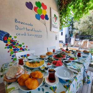 a table with plates of food on it at Nilada Bozcaada in Bozcaada