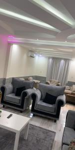 a living room with two couches and a table at صلاح ليما -1 in Dammam