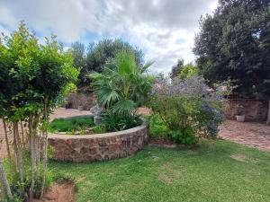 a garden with a stone circle in the grass at At Ease Road Lodge in Zeerust