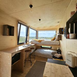 a tiny house with a desk and a bed at Tiny House au milieu des Vignes in Arbis