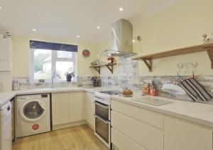 a kitchen with a washing machine and a washer at Sparrows, Wangford nr Southwold in Wangford
