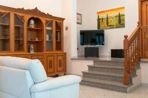 a living room with a staircase and a tv at A Casa di Rut - Appartamento in Moiano