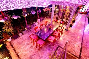an overhead view of a purple table and chairs at Aman Homestay, A Boutique Hotel in Agra