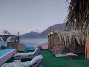 a room with chairs and a view of the water at Perry’s Island Camp Al Mezina in Nuweiba