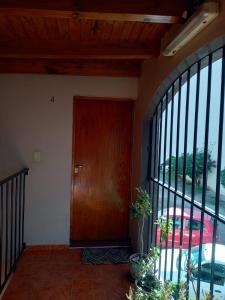 a wooden door in a room with a window at Complejo Cerrado Zona Shopping in Guaymallen