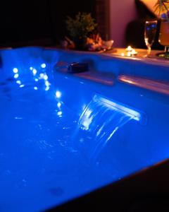 a blue pool of water with a plastic object in it at chambre romantique avec spa privatif in Ferrière-la-Grande