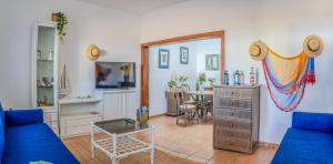 a living room with a blue couch and a table at SONRYE Graciosa in Caleta de Sebo