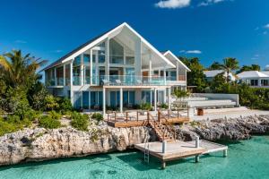a house on a cliff in the water at La Mer South, Luxury Oceanfront on Sapodilla Bay in Providenciales