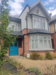 a brick house with a blue door at Remarkable 7-Bed House in London in London