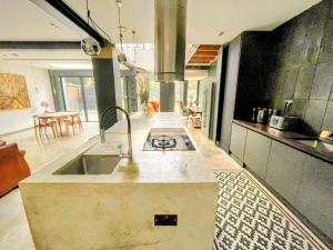a kitchen with a sink and a stove in it at Remarkable 7-Bed House in London in London
