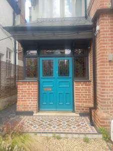 a blue door on the side of a brick building at Remarkable 7-Bed House in London in London