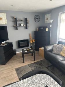 a living room with a couch and a table at Ground Floor Hillview 2 bedroom Apartment in Brean
