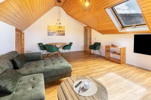 a living room with a couch and a table at Ferienwohnungen Martin Lafar in Öhningen