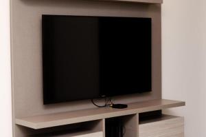 a flat screen tv on a shelf in a living room at N3-Catamarca in Villa Constitución