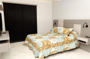 a bedroom with a bed and two night stands at N3-Catamarca in Villa Constitución