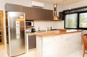 a kitchen with a stainless steel refrigerator and a counter at N3-Catamarca in Villa Constitución +6 photos