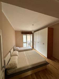 a bedroom with two beds and a window at You will love it in Durrës
