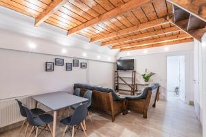 a living room with a table and chairs at Alborella Vendégház in Fadd