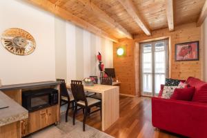 a living room with a red couch and a table at Locanda Cantù in Carona