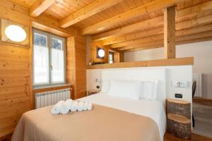 a bedroom with two beds in a wooden cabin at Locanda Cantù in Carona