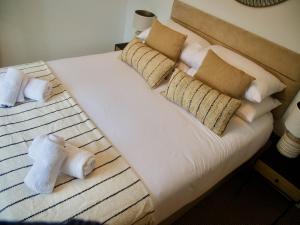 a bed with towels and pillows on it at Combe Hill Apartments in Ilfracombe