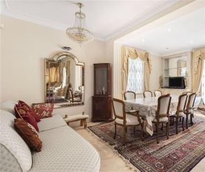 a living room with a table and chairs and a couch at Large 5 Bedroom house in Finchley in Maida Vale