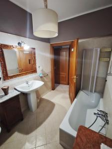 a bathroom with a tub and a sink and a bath tub at B&B A Casa di Mael in San Costanzo +112 photos