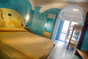 a bedroom with a bed and a staircase in it at Hotel Stella Maris in Cesenatico