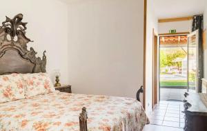 a bedroom with a bed and a sliding glass door at 9Arches in Vila Nova de Poiares