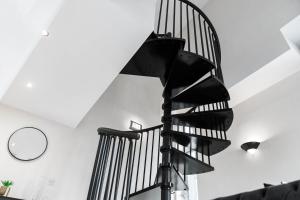 a black spiral staircase in a white room at Duplex Penthouse Apartment - Birmingham City Centre - Secure Parking - Terrace 1401M in Birmingham