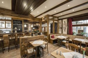 a restaurant with tables and chairs and a bar at Hotel Louis Müller in Bitburg