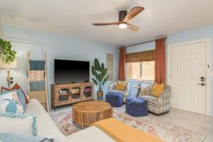 a living room with a couch and a tv at Luxury Home with Hot Tub & Outdoor Oasis blocks from the Beach in St. Pete Beach