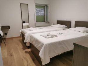 a group of three beds in a room at Résidence Alpina Caux in Montreux