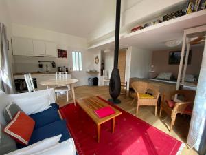 a living room with a blue couch and a table at Studio de l'oliveraie in Aix-en-Provence