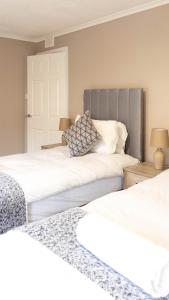 two beds sitting next to each other in a bedroom at Airth House in Airth