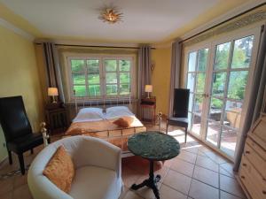 a bedroom with a bed and a table and chairs at Chalet am Kurpark in Boppard