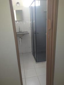 a bathroom with a shower and a sink at Hostel Araucaria in Ribeirão Preto