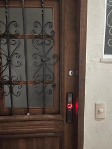 a close up of a wooden door with a red light at Ap Copa perto da praia e metrô in Rio de Janeiro