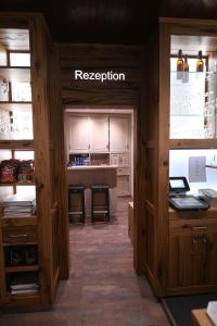 a kitchen with wooden cabinets and a kitchenasteryasteryasteryasteryasteryasteryasteryastery at Hotel Louis Müller in Bitburg