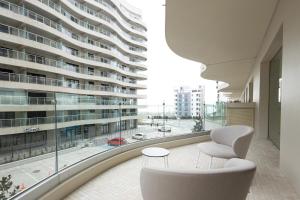 a room with a large building with a large window at Nordis Hotel Mamaia in Mamaia