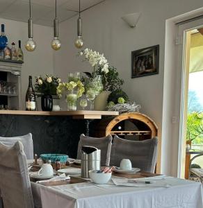 a dining room with a table with chairs and flowers at Pension Zur Alten Post in Havelberg