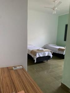 una camera ospedaliera con due letti e un tavolo di Hostel Araucaria a Ribeirão Preto