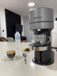 a coffee maker on a counter with a cup of coffee at Altazona - Living 73 in Panama City