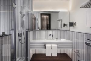 a bathroom with a sink and a shower at DeCamondo Galata, a Tribute Portfolio Hotel in Istanbul