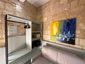 a room with a couch and a painting on the wall at Lorenzo x Casa Norte in Birgu