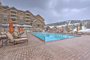 a swimming pool with lounge chairs and a hotel at Ski-InandSki-Out Condo in Park City with 6 Balconies! in Park City