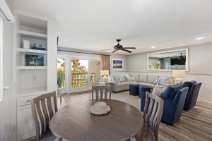 a living room with a table and a couch at 8A Seagrove Villa in Isle of Palms