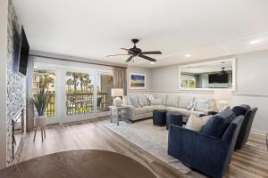 a living room with a couch and a ceiling fan at 8A Seagrove Villa in Isle of Palms