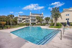 a swimming pool in front of a apartment building at 8A Seagrove Villa in Isle of Palms