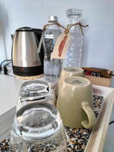 um balcão com 2 garrafas de vidro e uma chaleira para chá em LOCANDA VECCHIO NOVECENTO 